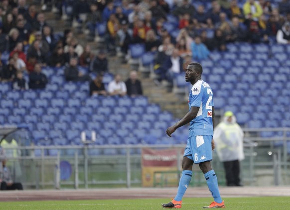 Napoli&#039;s Kalidou Koulibaly walks the pitch as the match was briefly suspended because fans were making racist chants against him, during an Italian Serie A soccer match between Roma and Napoli, a ...