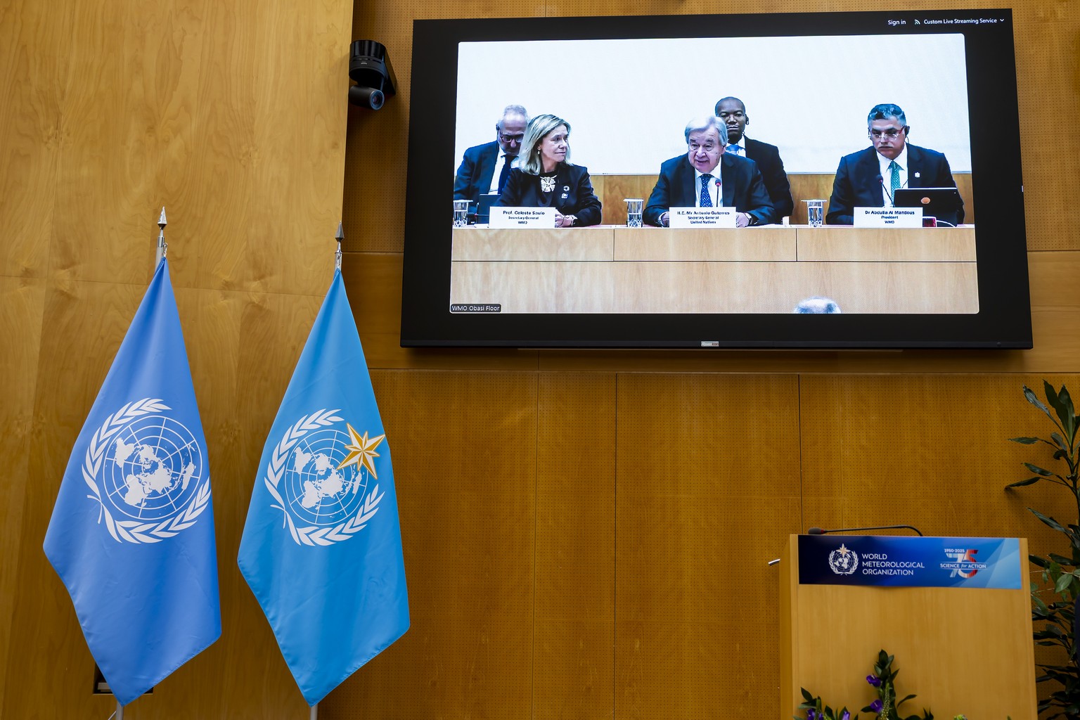 A screen shows the U.N. Secretary-General Antonio Guterres, center, sitting between Celeste Saulo, left, Secretary-General of World Meteorological Organization (WMO), and Abdulla Ahmed Al Mandous, rig ...