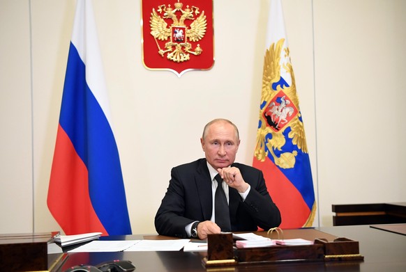 Russian President Vladimir Putin attends a video conference with officials from the southern province of Dagestan at the Novo-Ogaryovo residence outside Moscow, Russia, Monday, May 18, 2020. Putin ple ...