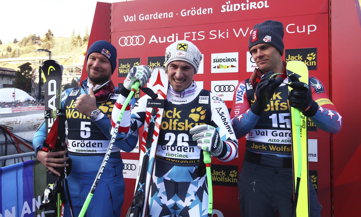 From left, Norway's Aksel Lund Svindal, Austria's Max Franz and United States' Steven Nyman celebrate after finishing an alpine ski, men's World Cup downhill, in Val Gardena, Italy ...