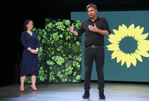 Germany&#039;s Green party co-leader Robert Habeck, right, presents co-leader Annalena Baerbock, left, at a digital announcement event in Berlin, Germany, where the party presented her as top candidat ...