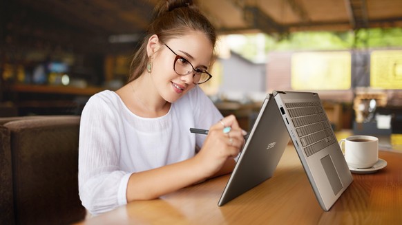 Portrait of smiling hipster guy in trendy wear having mobile phone conversation while sitting outdoors with laptop computer, adult man student making cellphone call in roaming looking at camera; Shutt ...
