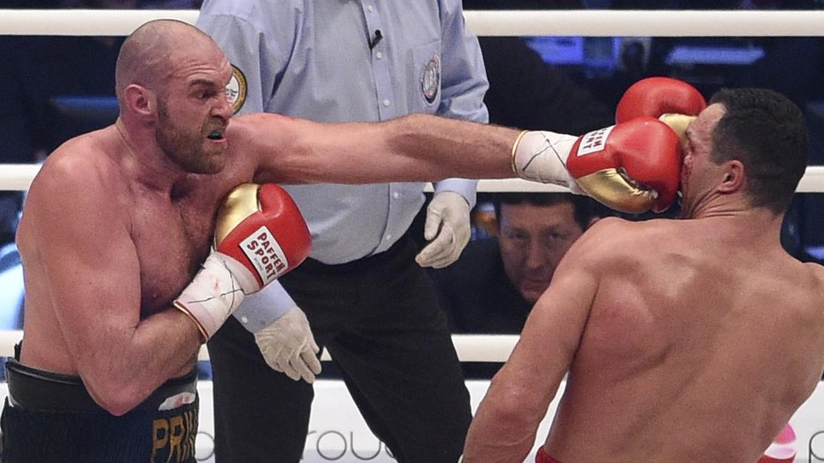 Britain's Tyson Fury, left, punches Ukraine's Wladimir Klitschko and in a world heavyweight title fight for Klitschko's WBA, IBF, WBO and IBO belts in the Esprit Arena in Duesseldorf, w ...