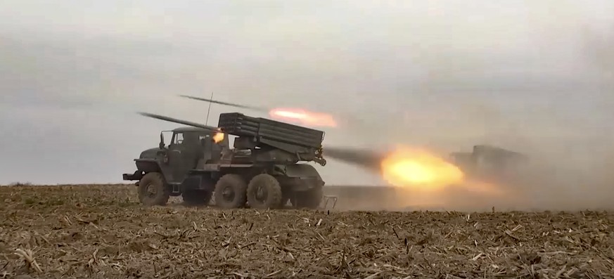 In this handout photo from a video released on Wednesday, November 23, 2022 by the press service of the Russian Ministry of Defense, multiple rocket launchers of the Russian military fire missiles during an artillery and…