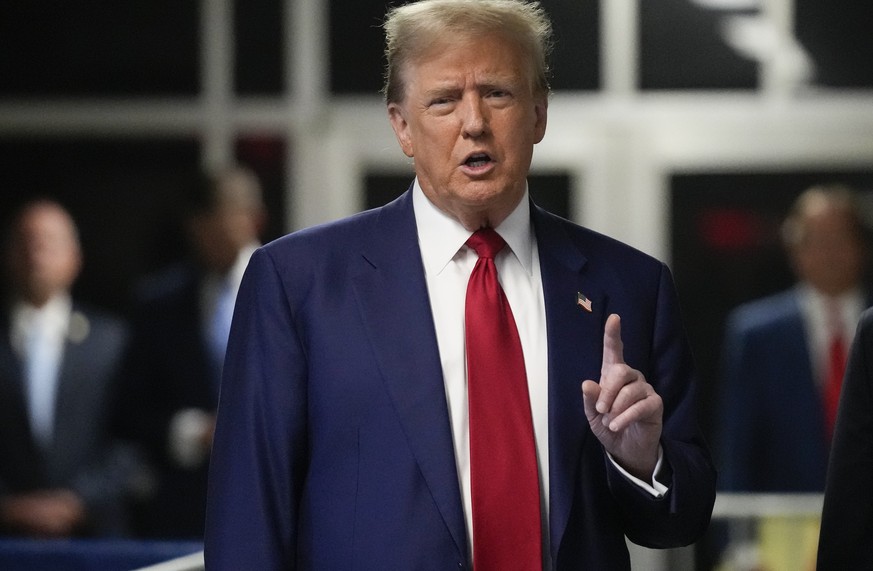 epa11310155 Former US President Donald Trump gestures while speaking to the media upon arrival for his criminal trial at the New York State Supreme Court in New York, New York, USA, 30 April 2024. Tru ...