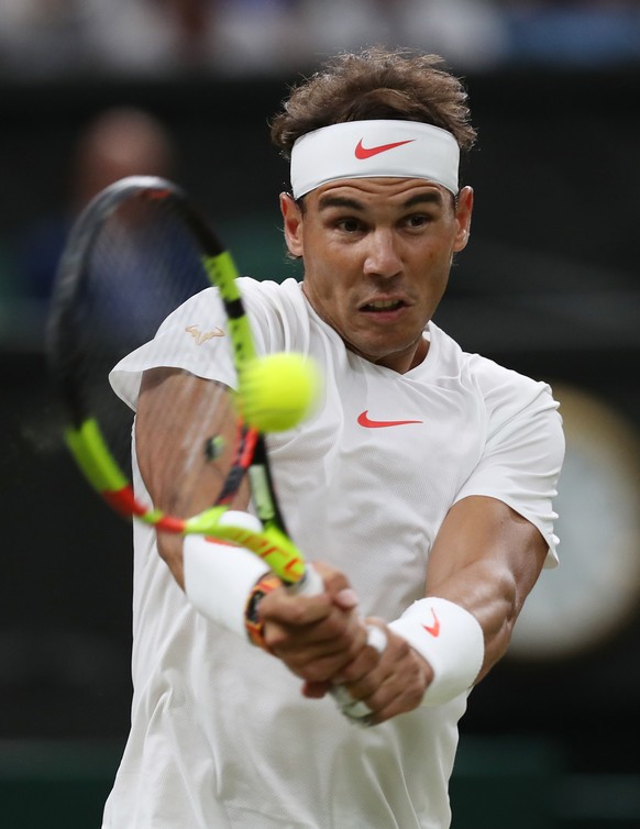 Rafael Nadal of Spain returns a ball to Novak Djokovic of Serbia during their men&#039;s singles semifinal match at the Wimbledon Tennis Championships, in London, Friday July 13, 2018. (AP Photo/Danie ...