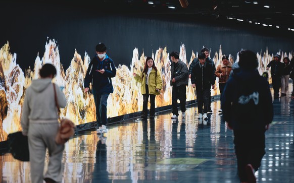 epa11937458 People walk in the underground passage in Shanghai, China, 03 March 2025. The Caixin China General Manufacturing PMI rose to 50.8 in February 2025, up from 50.1 the previous month and surp ...
