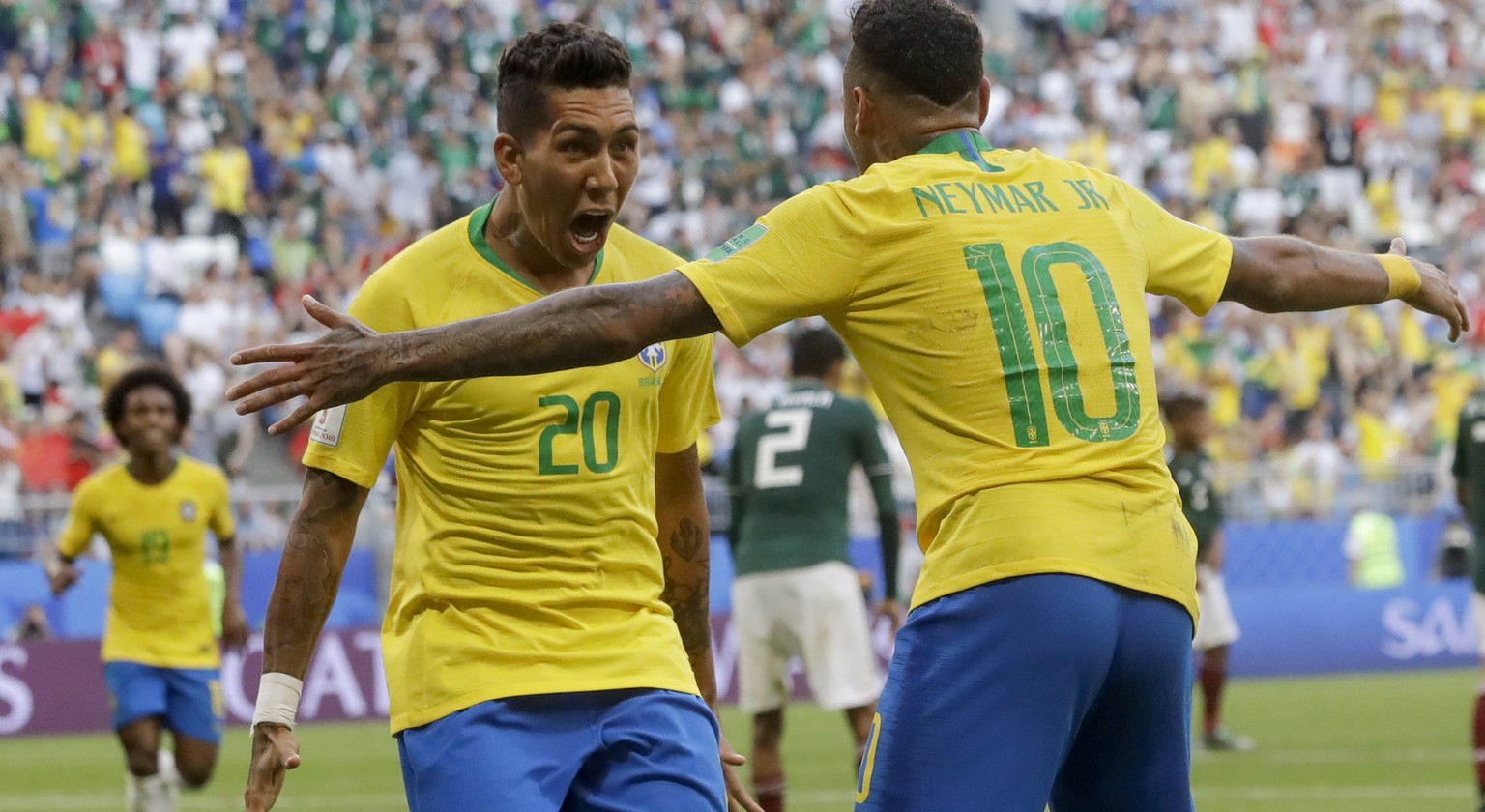 Brazil&#039;s Roberto Firmino, left, celebrates with Brazil&#039;s Neymar, right, after scoring his side&#039;s second goal during the round of 16 match between Brazil and Mexico at the 2018 soccer Wo ...