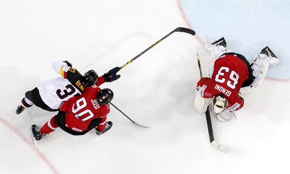 Switzerland&#039;s goaltender Leonardo Genoni, right, blocks the puck past Germany&#039;s Patrick Reimer, left, and Switzerland&#039;s Roman Josi, center, during the IIHF 2015 World Championship preli ...