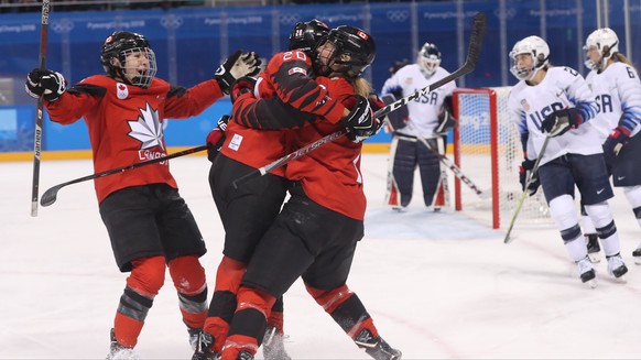 epa06526866 Canada players (L) celebrate a goal against the USA during a preliminary Women's Ice Hockey match between USA and Canada at the Kwandong  Hockey Centre during the PyeongChang Winter Olympic Games 2018, in Gangneung, South Korea, 15 February 2018.  EPA/JAVIER ETXEZARRETA