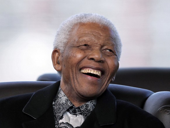 FILE - In this, Saturday, May 9, 2009 file photo, South Africa's former President Nelson Mandela smiles as newly appointed President Jacob Zuma makes his speech during his Inauguration in Pretori ...