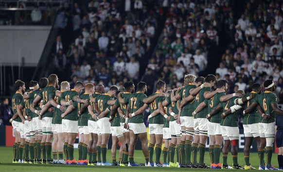 The South Africa team link arms before the start of the Rugby World Cup final at International Yokohama Stadium between England and South Africa in Yokohama, Japan, Saturday, Nov. 2, 2019. (AP Photo/Aaron Favila)