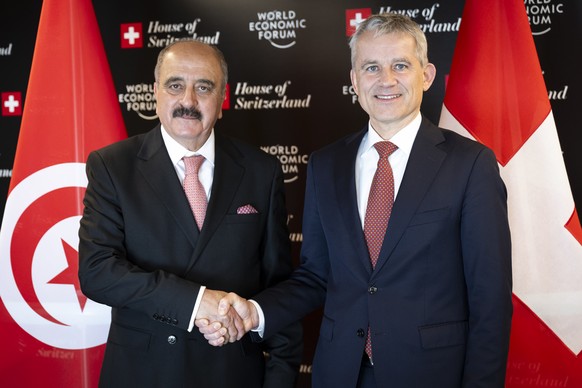 Tunisian Foreign Minister Mohamed Ali Nafti, left, and Switzerland&#039;s minister of Justice and Police Federal Councillor Beat Jans, right, shakes hands prior to a bilateral meeting on the sideline  ...