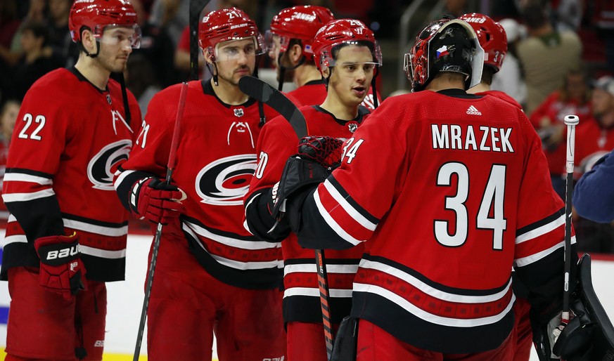 Carolina Hurricanes goaltender Petr Mrazek (34) is congratulated on his 8â??2 win over Ottawa Senators by teammate Sebastian Aho (20), of Finland, at an NHL hockey game in Raleigh, N.C., Monday, Nov.  ...