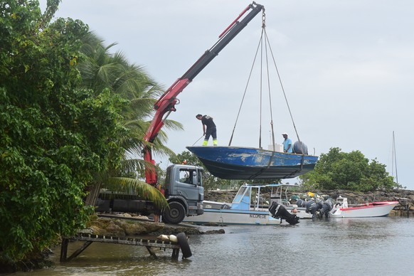 Men remove boats from the water ahead of Hurricane Maria in the Galbas area of Sainte-Anne on the French Caribbean island of Guadeloupe, early Monday, Sept. 18, 2017. Hurricane Maria grew into a Categ ...