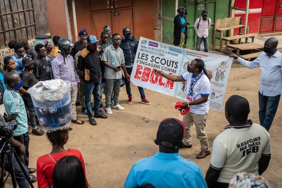 Francois Kasereka, a member of the Congo Scouts movement, speaks to people during a public sensitisation campaign amid the Ebola outbreak in Bunia, Congo, Saturday, May 23, 2026. (AP Photo/Moses Sawas ...