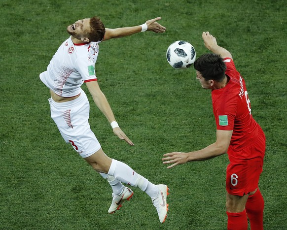 Tunisia&#039;s Rami Bedoui, right. and England&#039;s Jordan Henderson challenge for the ball during the group G match between Tunisia and England at the 2018 soccer World Cup in the Volgograd Arena i ...