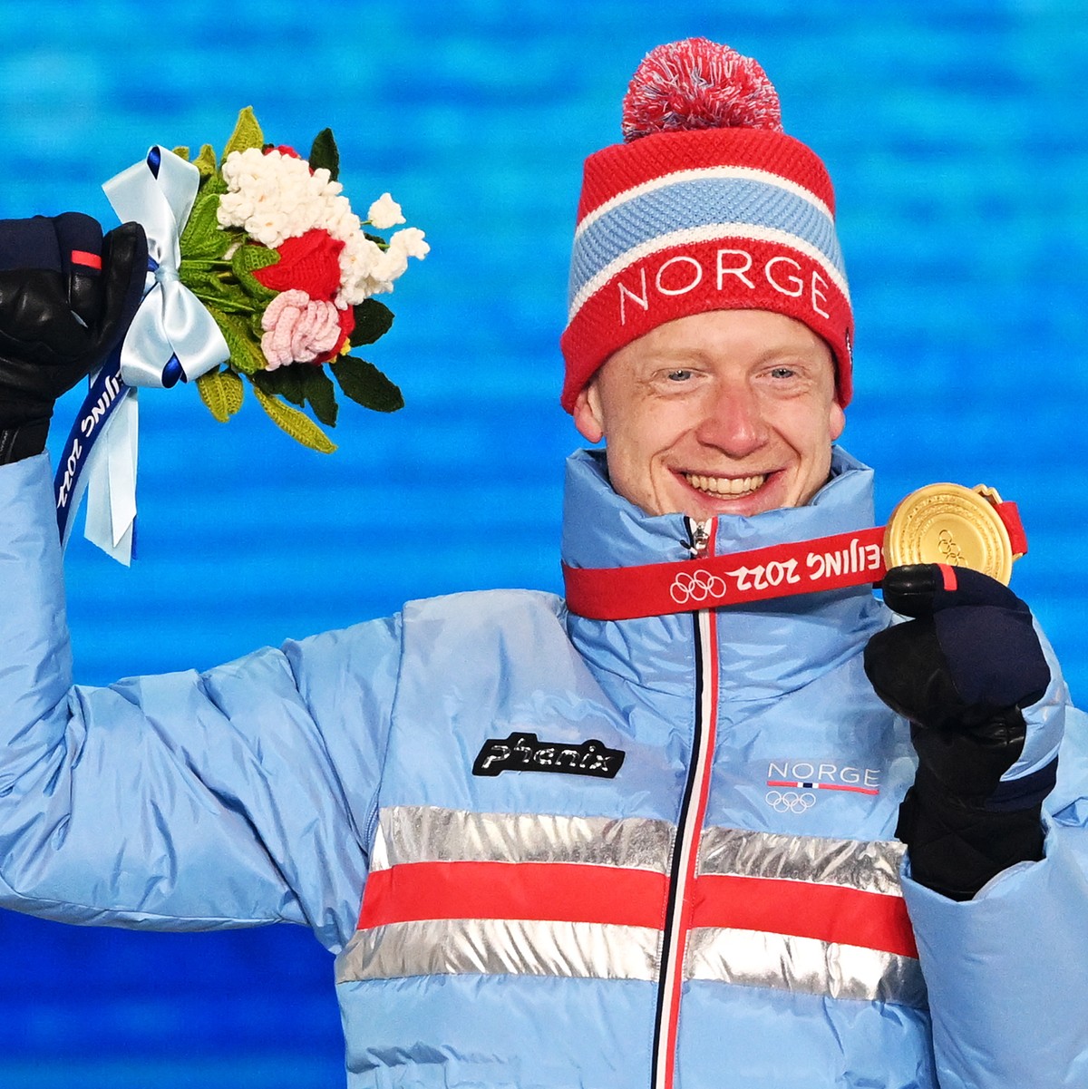 epa09755546 Gold medalist Johannes Thingnes Boe of Norway during the medal ceremony for the Men's Biathlon 10km Sprint race at the Beijing 2022 Olympic Games, Zhangjiakou, China, 14 February 2022 ...