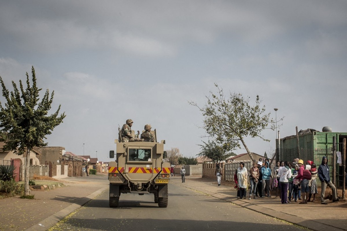 A South African National Defence Force armoured vehicle enters a section of the restive Bekkersdal township on May 6, 2014. South Africa goes to polls on May 7, 2014 in the fifth democratic elections  ...