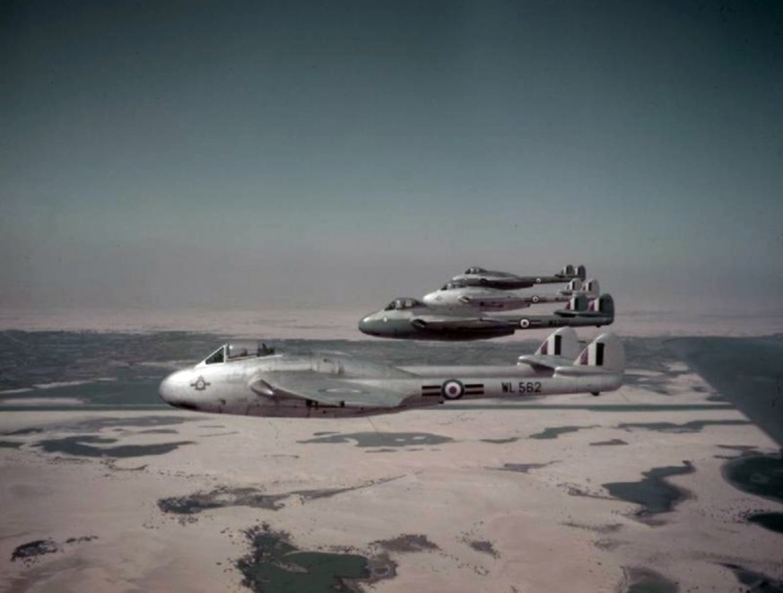 Four Royal Air Force De Havilland Vampire FB.9s in line abreast formation (WL582, WX207, WL615, WX218) over Egyptian desert. These aircraft were from No 213 Squadron based at RAF Deversoir, in the Sue ...