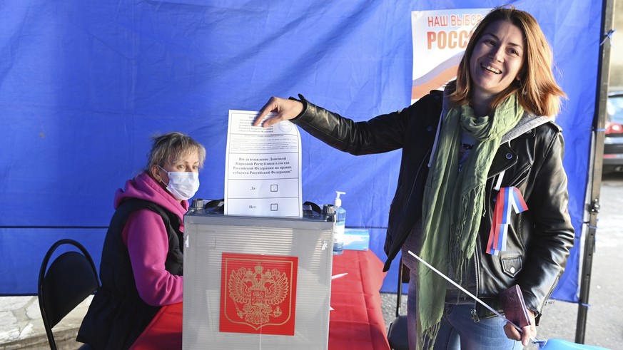 A woman who lives in Russia, from the Donetsk region, the territory controlled by a pro-Russia separatist government, holds her ballot during a referendum at a temporary accommodation facility in the  ...