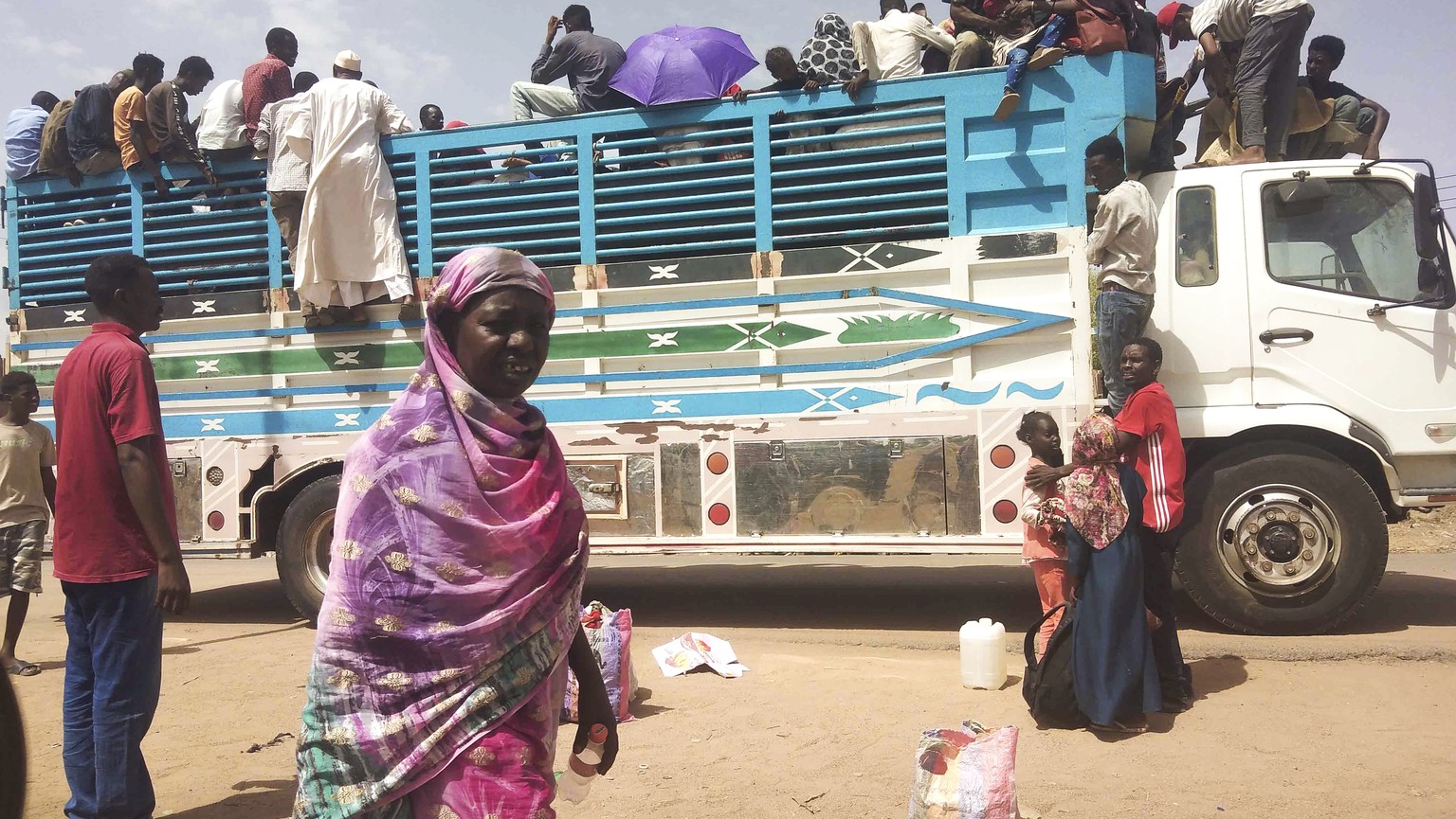 FILE - People board a truck as they leave Khartoum, Sudan, on June 19, 2023. Sudan has been torn by war for a year now, torn by fighting between the military and the notorious paramilitary Rapid Suppo ...