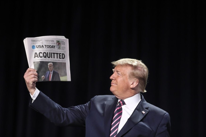 epa08197934 US President Donald J. Trump holds a copy of the USA Today newspaper fronting with his Impeachment acquittal, as he arrives to the 68th Annual National Prayer Breakfast in Washington, DC, ...