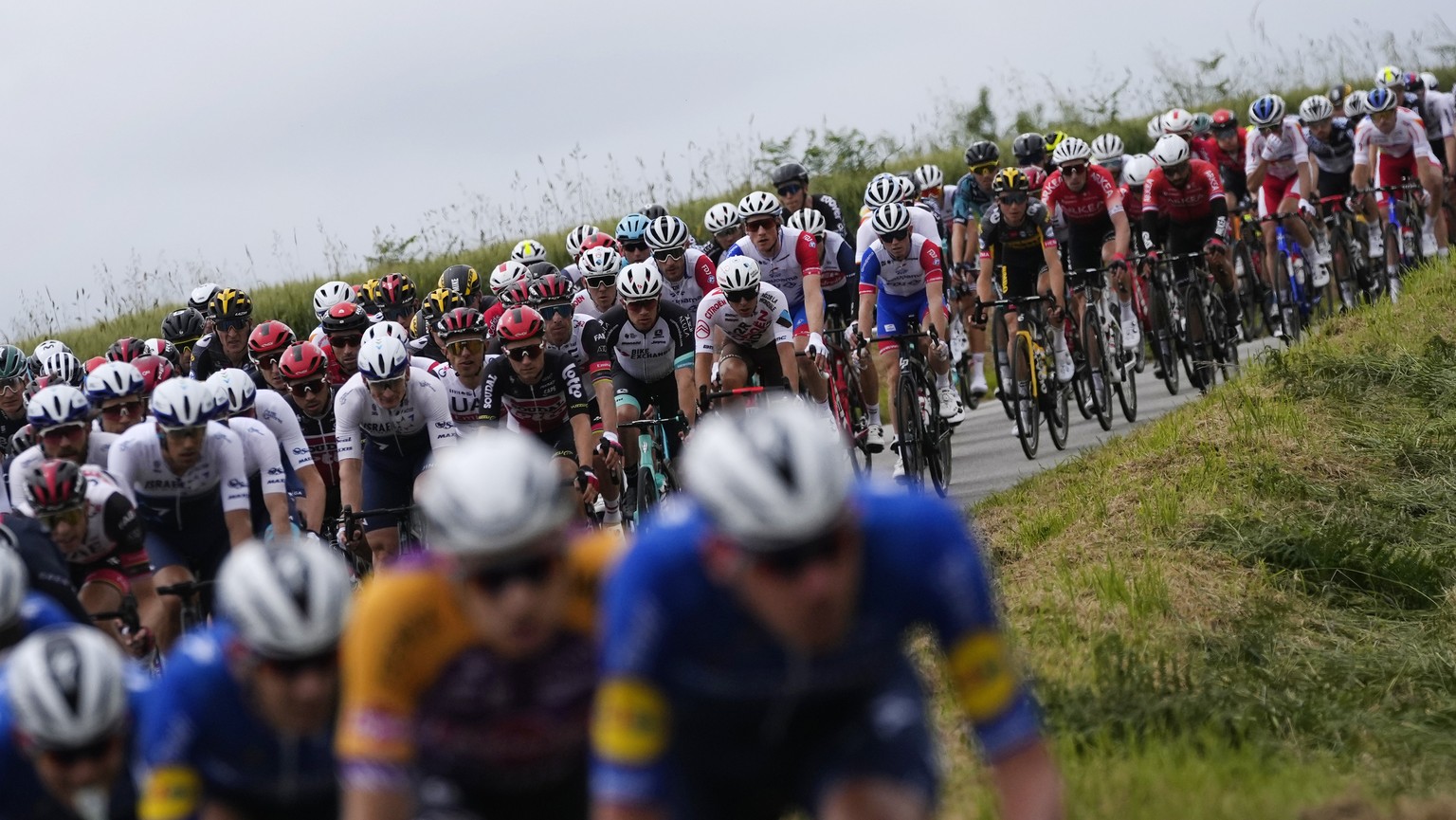 The pack rides during the first stage of the Tour de France cycling race over 197.8 kilometers (122.9 miles) with start in Brest and finish in Landerneau, France, Saturday, June 26, 2021. (AP Photo/Da ...