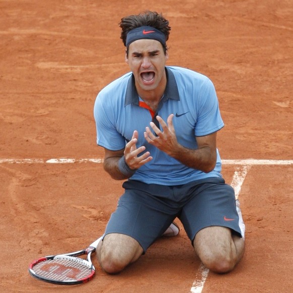 Switzerland's Roger Federer jubilates after defeating Sweden's Robin Soderling during their men's singles final match of the French Open tennis tournament at the Roland Garros stadium i ...