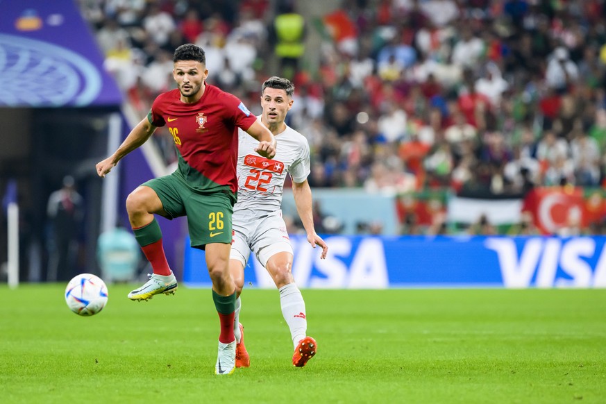 Portugal&#039;s forward Goncalo Ramos, left, fights for the ball with Switzerland&#039;s defender Fabian Schaer, right, during the FIFA World Cup Qatar 2022 round of 16 soccer match between Portugal a ...