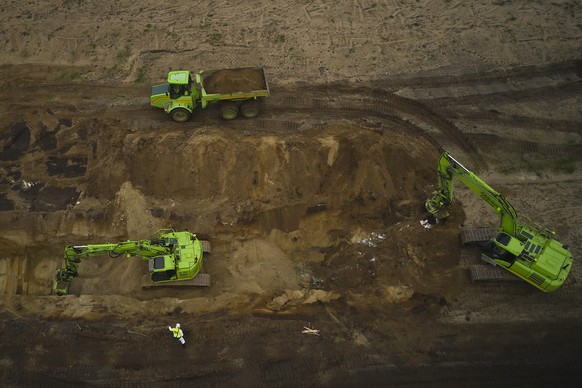 Buried mink are excavated in a trial excavation for the animals to be incinerated, at a military area close to Noerre Felding, Denmark, on Wednesday May 13, 2021. Around four million mink were buried  ...