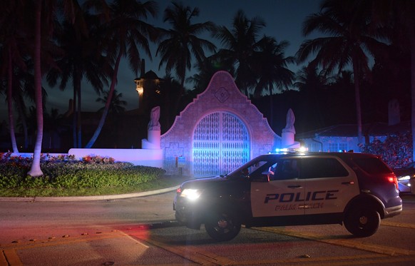 epa10112024 Authorities stand outside Mar-a-Lago, the residence of former president Donald Trump, amid reports of the FBI executing a search warrant as a part of a document investigation, in Palm Beac ...