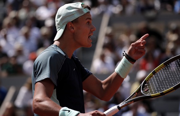 epa09986359 Holger Rune of Denmark reacts as he plays Stefanos Tsitsipas of Greece in their men?s fourth round match during the French Open tennis tournament at Roland ?Garros in Paris, France, 30 May ...