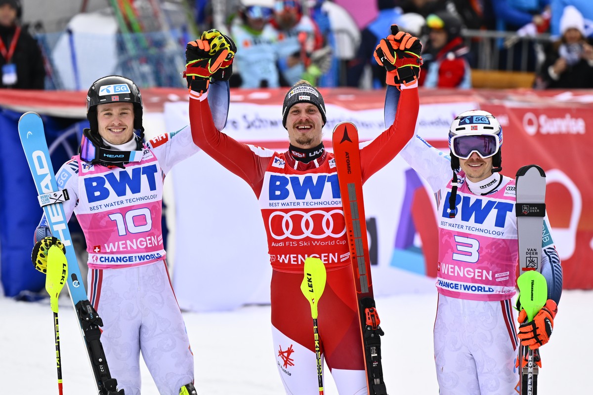 epa11076095 Winner Manuel Feller of Austria (C), second place Atle Lie McGrath of Norway (L), and third place Henrik Kristoffersen of Norway (R) celebrate in the finish area during the second run of t ...