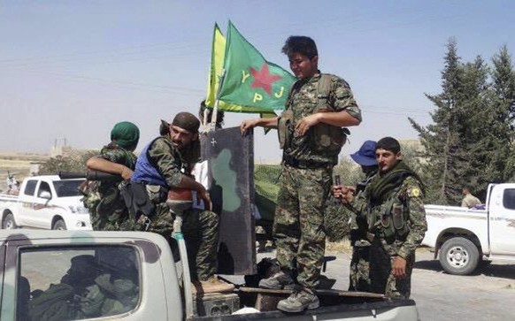 FILE - In this file photo released on Tuesday, June 23, 2015, provided by the Kurdish fighters of the People&#039;s Protection Units (YPG), which has been authenticated based on its contents and other ...