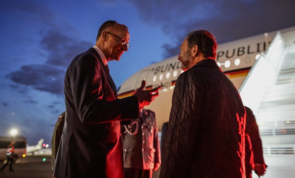 epa12081856 German Chancellor Friedrich Merz (L) boards his plane in Warsaw, Poland, 07 May 2025. The German Chancellor visits France and Poland the day after his election. EPA/HANNIBAL HANSCHKE