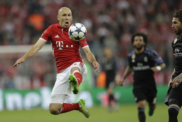 Bayern&#039;s Arjen Robben jumps for the ball against Real Madrid&#039;s Sergio Ramos during the Champions League quarterfinal first leg soccer match between FC Bayern Munich and Real Madrid, in Munic ...