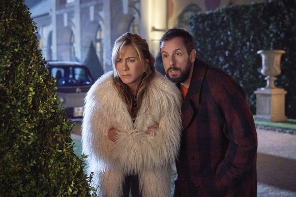 This image released by Netflix shows Jennifer Aniston, left, and Adam Sandler in a scene from the movie "Murder mystery 2." (Scott Yamano/Netflix via AP)