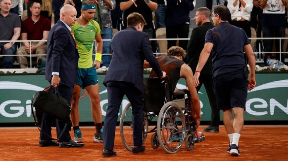 Mandatory Credit: Photo by Ella Ling/Shutterstock 12959951e Alexander Zverev of Germany is led off court in a wheelchair following a fall with Rafael Nadal looking on in concern French Open Tennis, Da ...