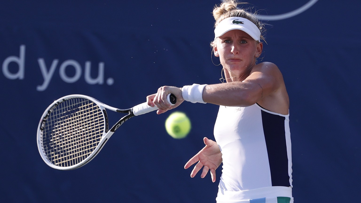 epa08621267 Jil Teichmann of Switzerland hits a return to Danielle Collins of the US during their first round match at the Western and Southern Open at the USTA National Tennis Center in Flushing Mead ...