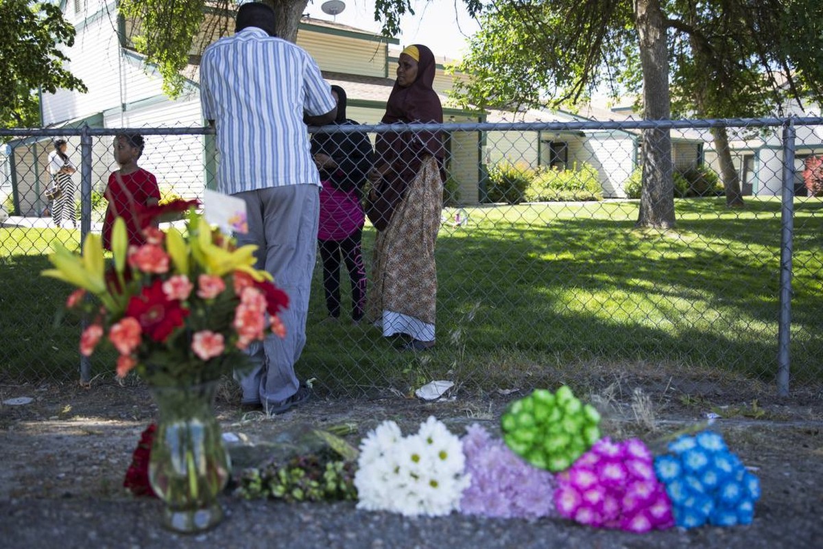 Ibod Hasn, center, talks to a friend who came to visit after Saturday's stabbing attack in Boise, Idaho, Sunday, July 1, 2018. A man who had been asked to leave an Idaho apartment complex because ...