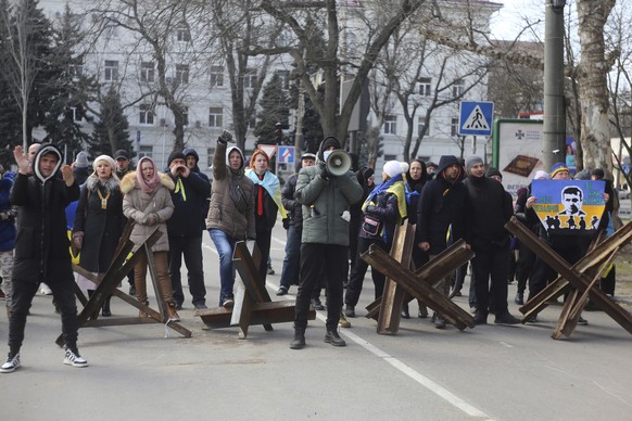 People shout towards Russian troops during a rally against the Russian occupation in Kherson, Ukraine, Friday, March 18, 2022. Ever since Russian forces took the southern Ukrainian city of Kherson in  ...