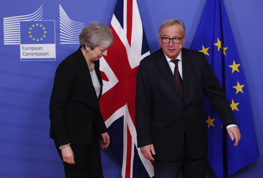 epa07383415 British Prime Minister Theresa May (L) is welcomed by European commission President Jean-Claude Juncker (R) ahead to a meeting on Brexit in Brussels, Belgium, 20 February 2019. May is in B ...