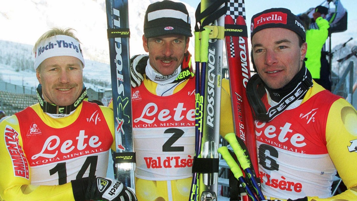 Swiss ski racer Michael von Gruenigen, center, who won today's giant slalom in Val d'Isere, France, Sunday, December 14, 1997, poses with his Swiss teammates Urs Kaelin, left, who finished f ...