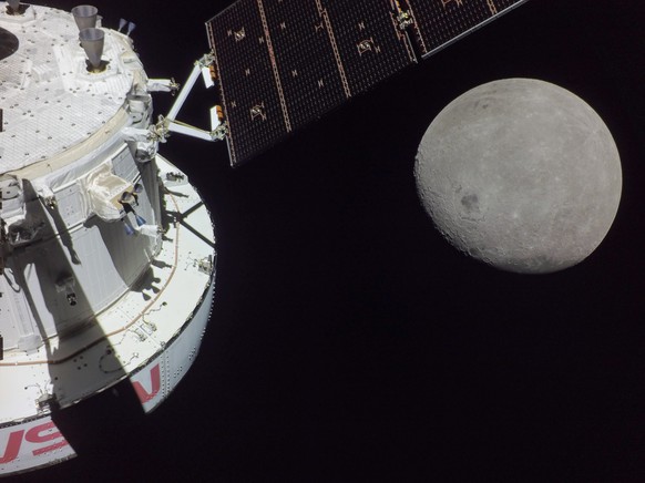 epa10320024 A handout photo made available by the NASA shows a portion of the far side of the Moon looms large just beyond the Orion spacecraft in this image taken on the sixth day of the Artemis I mi ...
