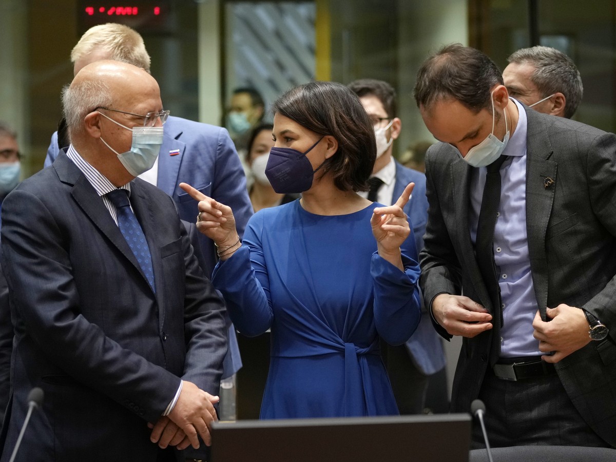 German Foreign Minister Annalena Baerbock, center, speaks with Portugal's Foreign Minister Augusto Santos Silva, left, and Slovenia's Foreign Minister Anze Logar, right, during a meeting of  ...