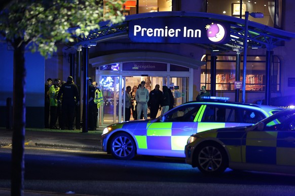 epa05982575 Armed officers guard outside a hotel near the Manchester Arena following reports of an explosion, in Manchester, Britain, 23 May 2017. According to a statement released by the Greater Manc ...