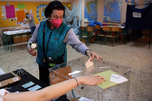 epa10642710 A woman casts her vote during the general elections at a polling station in Athens, Greece, 21 May 2023. Greek voters will go to the polls on 21 May 2023 to cast their ballots in the Greek ...