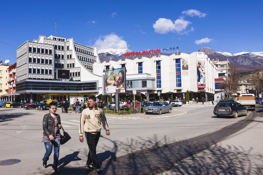 People in modern part of town, Peja, Kosovo.