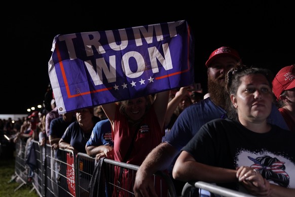 epa09488853 A supporter of former US President Donald Trump holds up a 'Trump Won' banner at a rally sponsored by 'Save America' at the Georgia National Fairgrounds in Perry, Georgia, USA, 25 Septembe ...